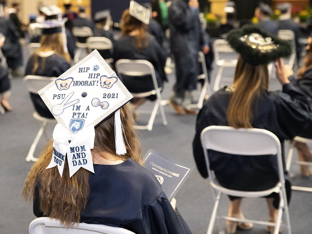 Graduates sit socially distanced as degrees are conferred