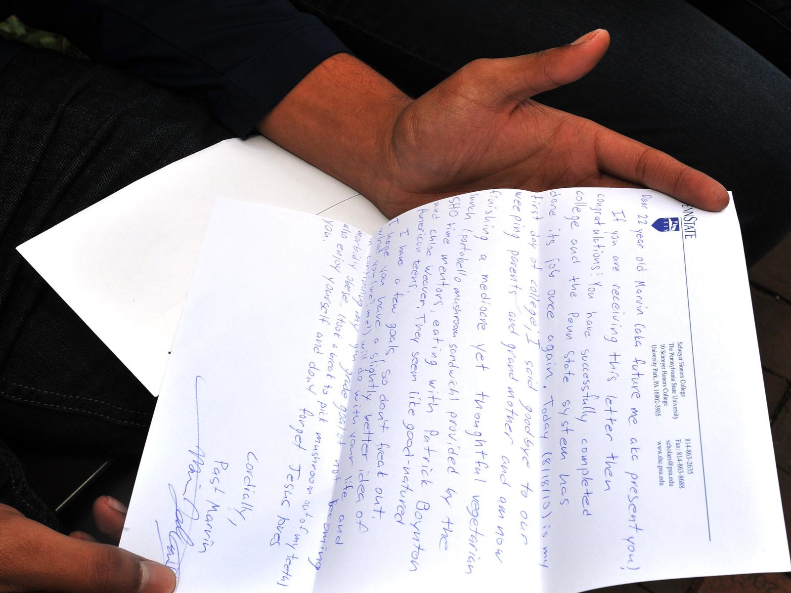 A Schreyer Scholar holds a letter written in 2010