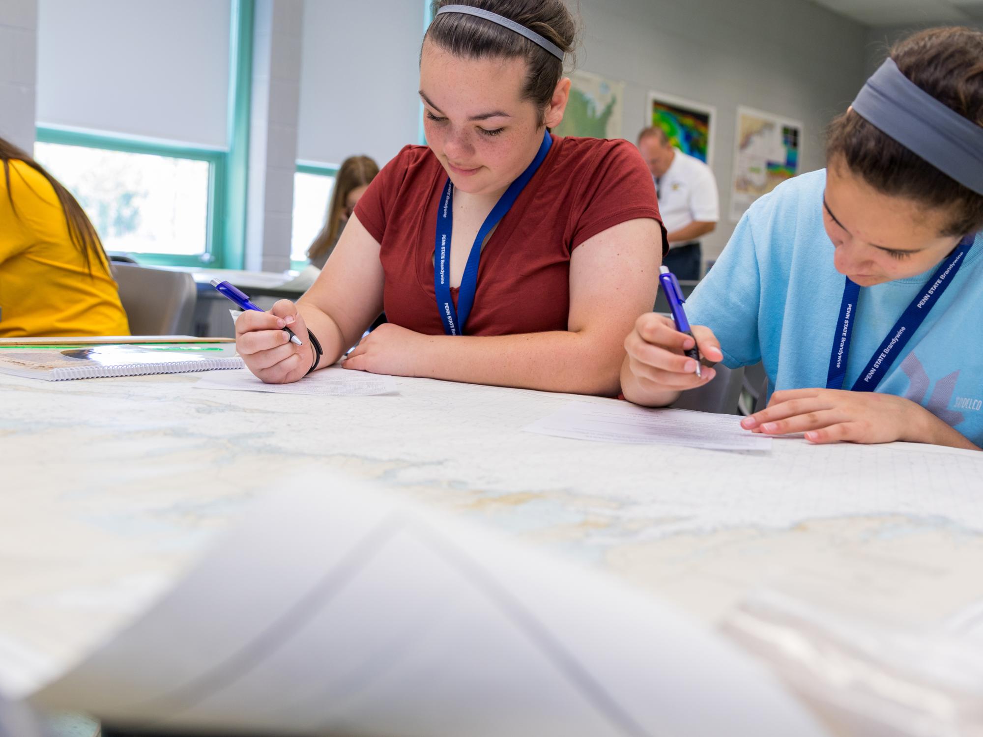 Girls working with nautical charts