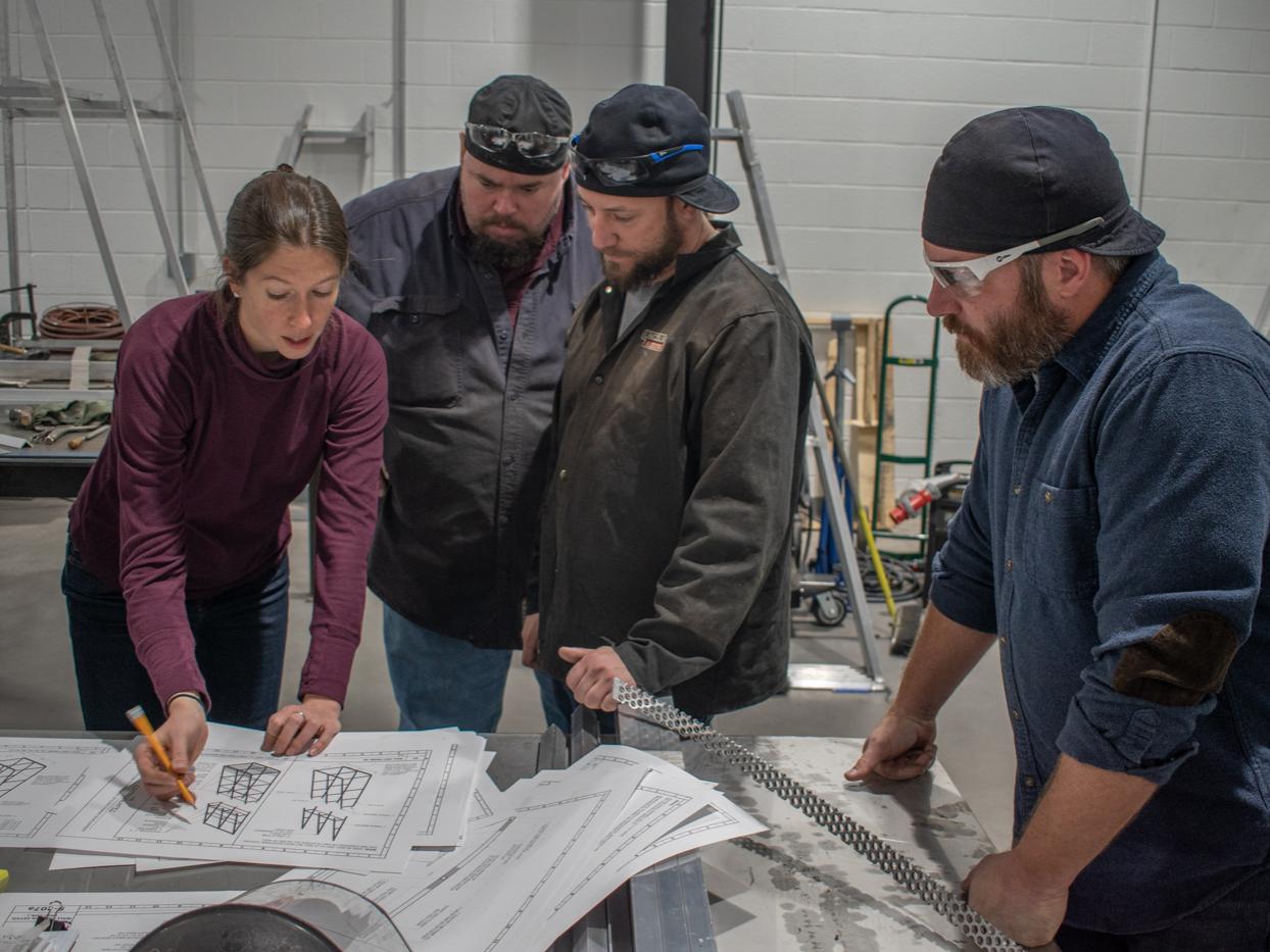 Gillean Denny, left, goes over design documents with three members of Pennsylvania College of Technology