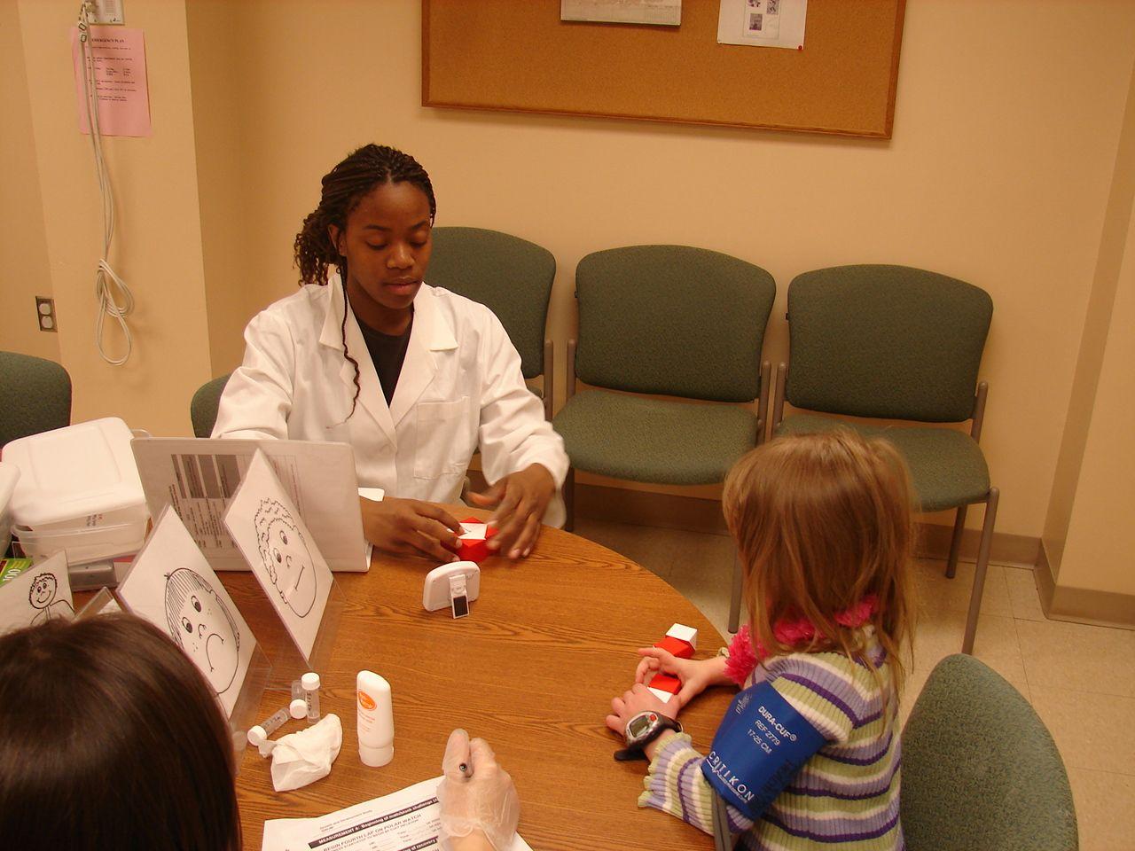 researcher and child with red blocks