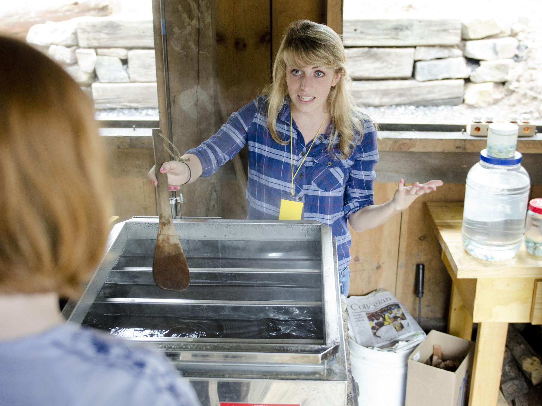 Student demonstrates maple syrup making.