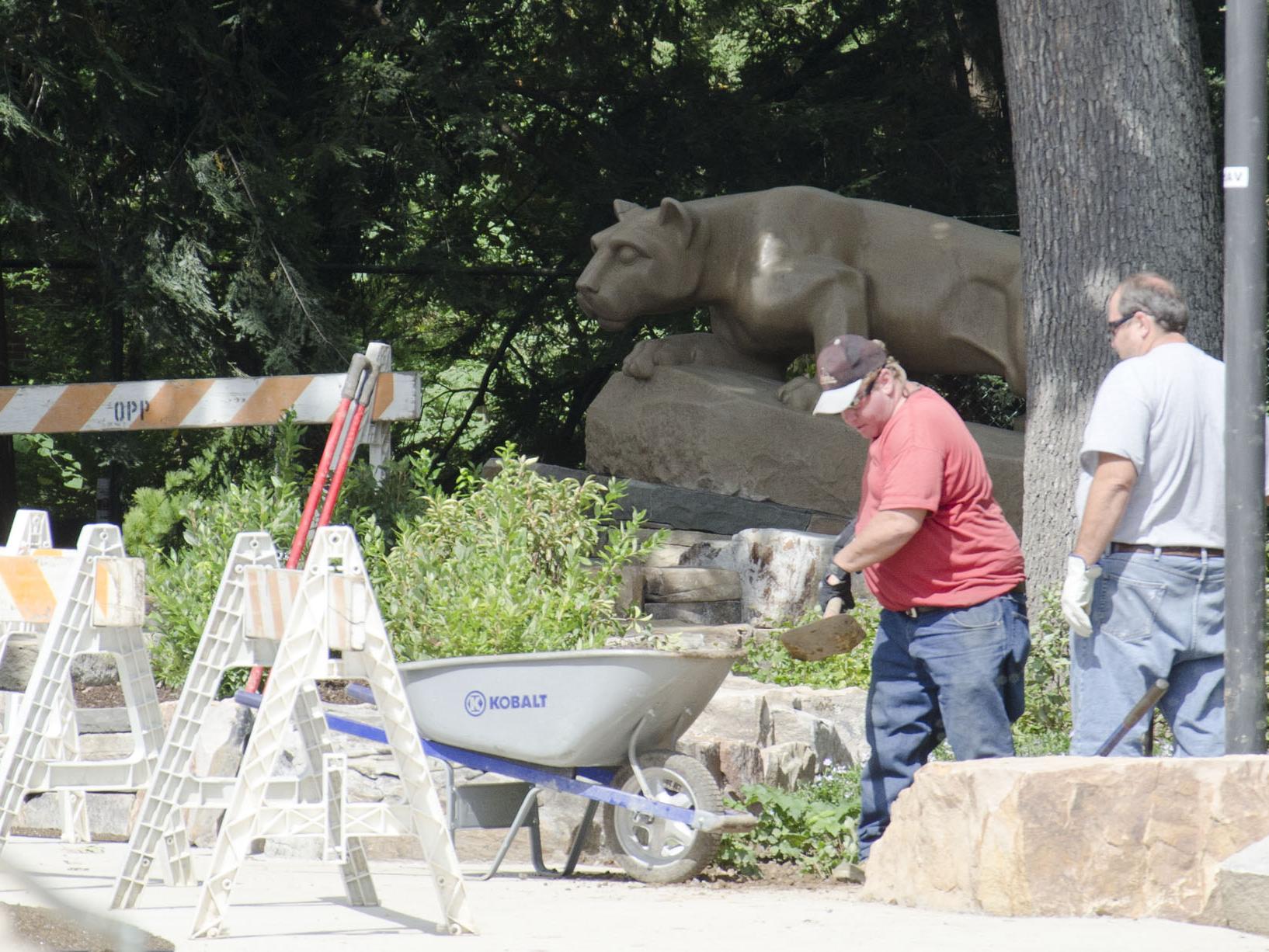 Workers at the Nittany Lion shrine