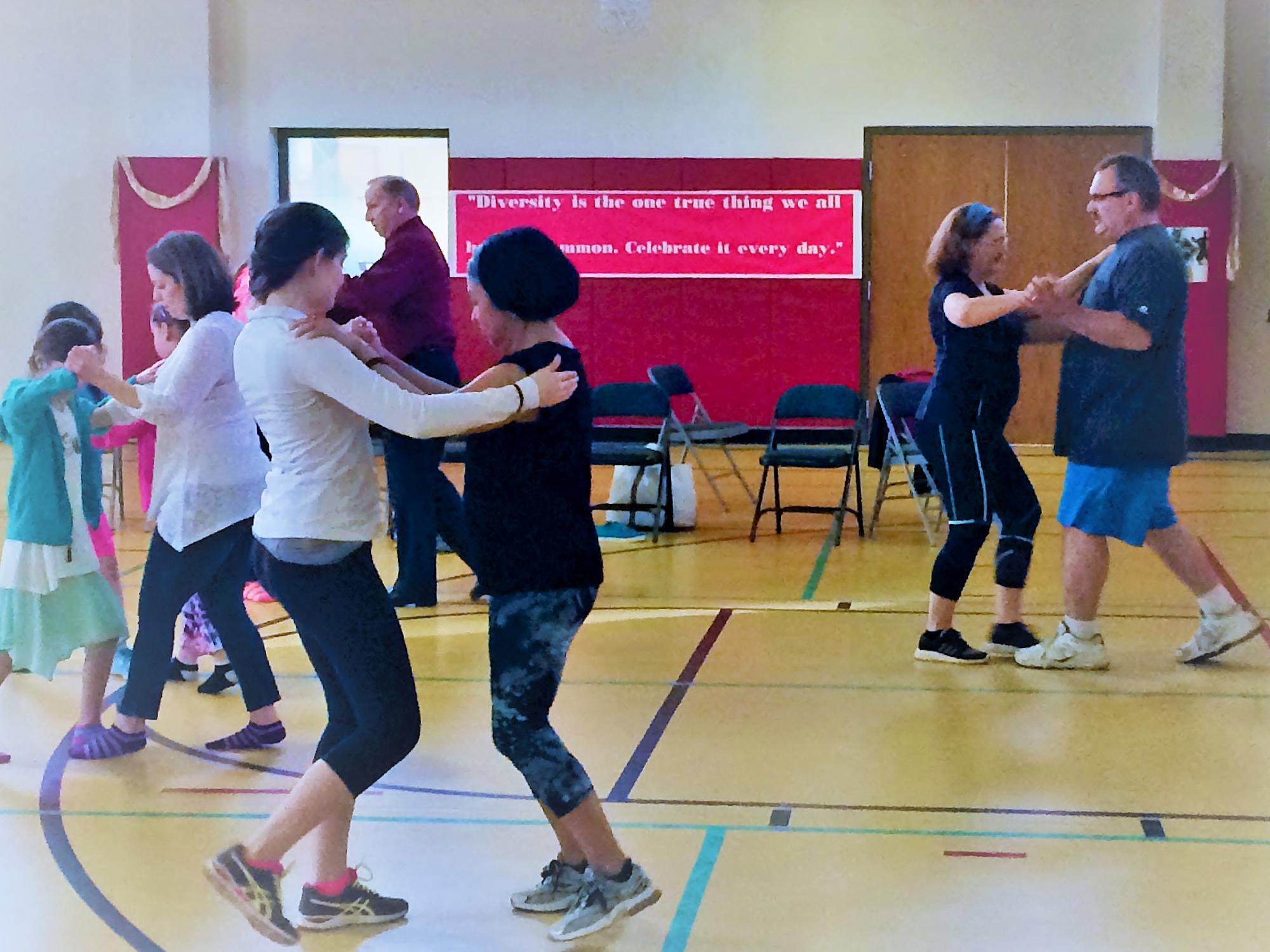 People dance at a program coordinated by Penn State Behrend students.
