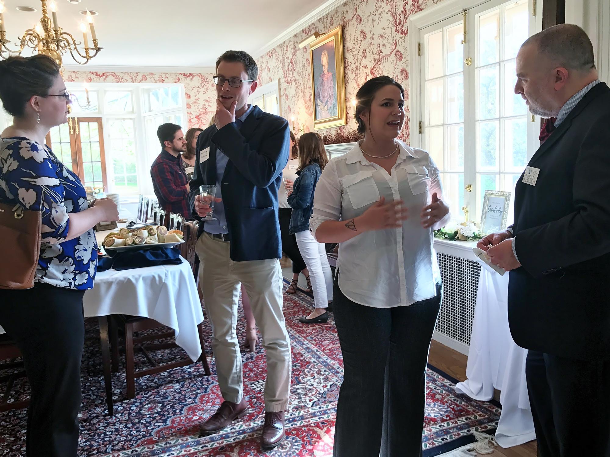 Artists and others mingle at a meet-and-greet reception coordinated by Nicole Krahe, an arts administration major at Penn State Behrend.