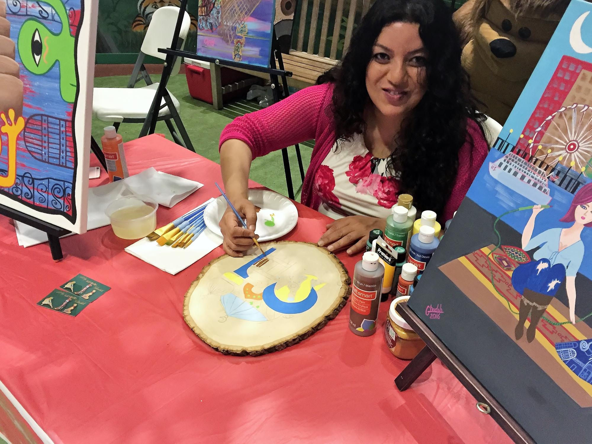 An artist paints at a program coordinated by a Penn State Behrend arts administration student.