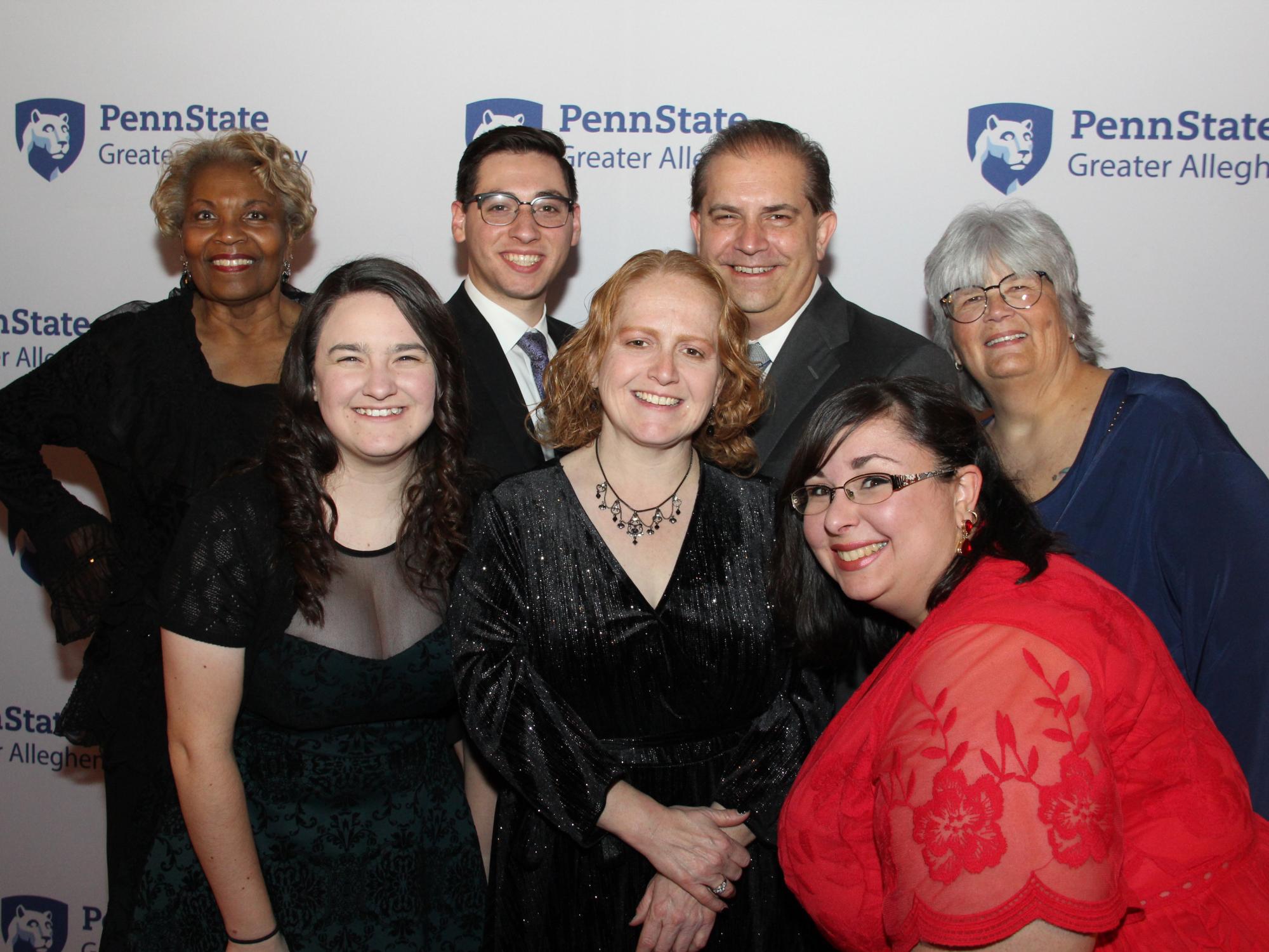 a group of people smiling at a camera