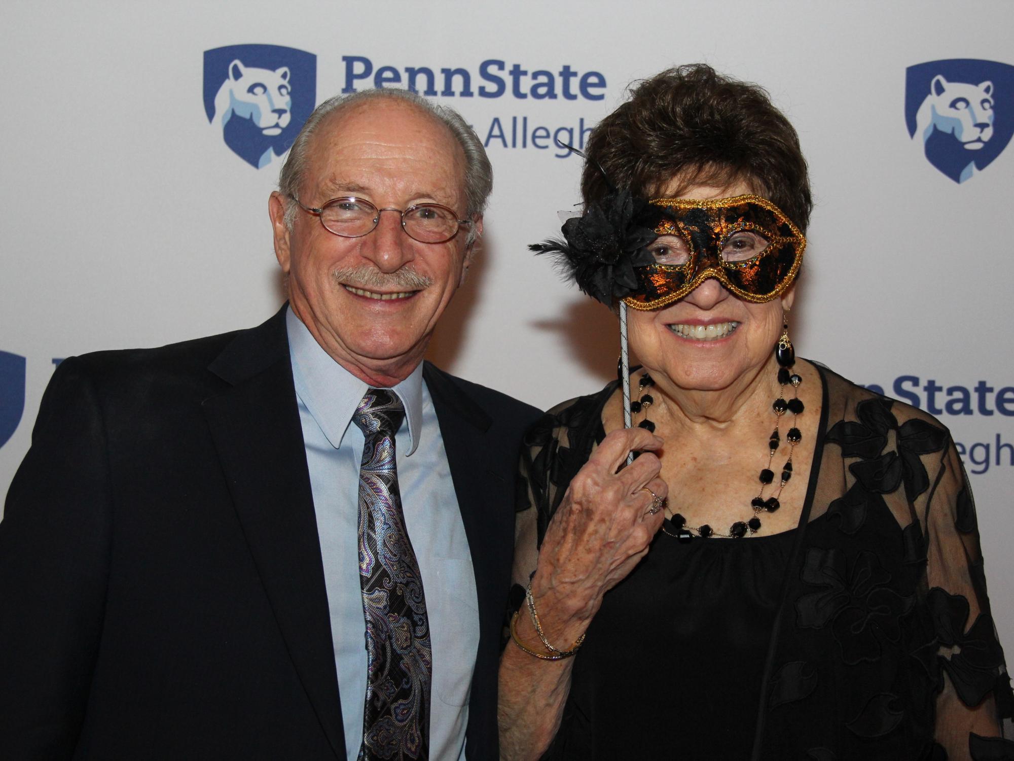 man smiling with women holding mask 