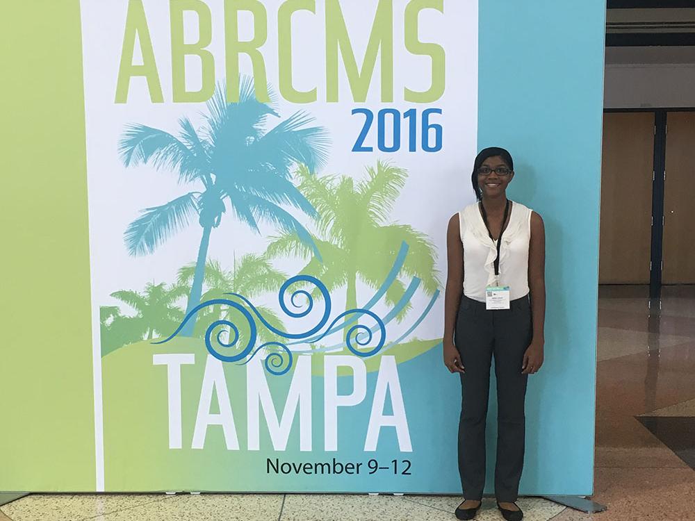amina grant poses at research conference