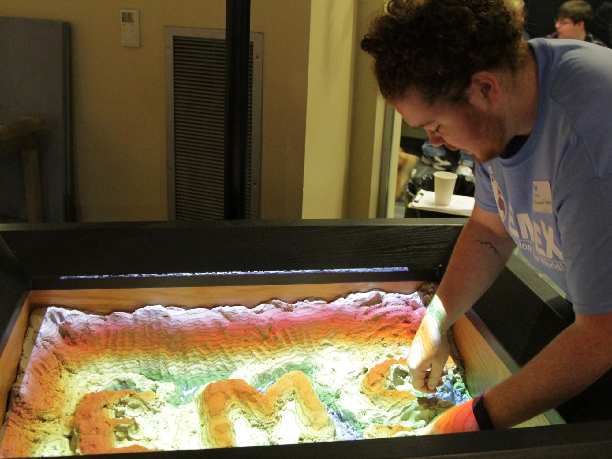 student playing in sandbox