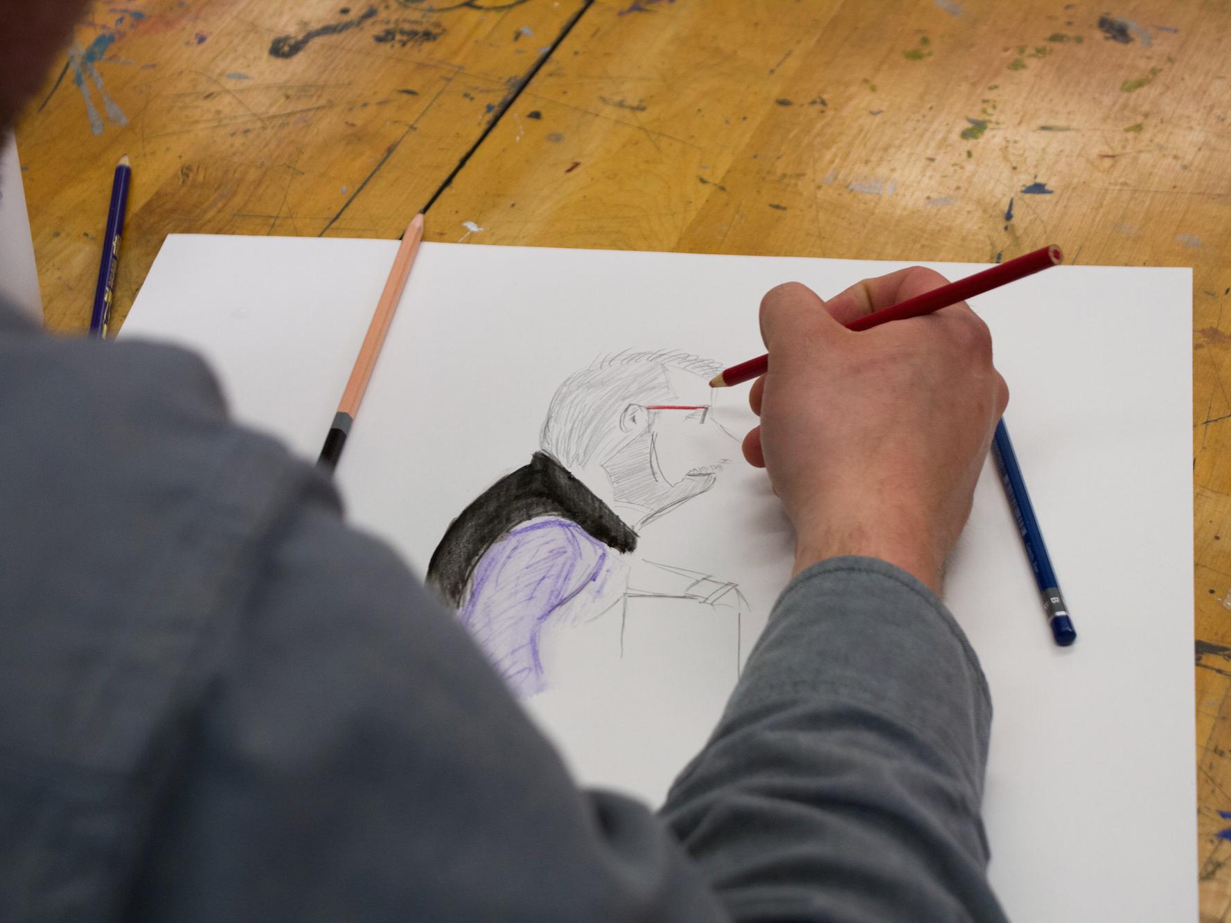 a staff member draws a picture