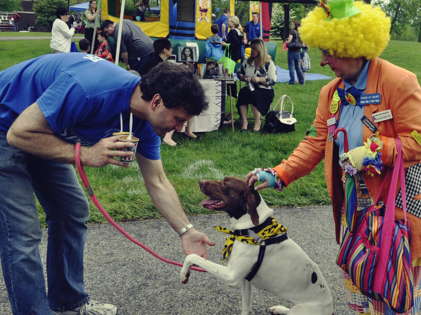 man with his dog and clown