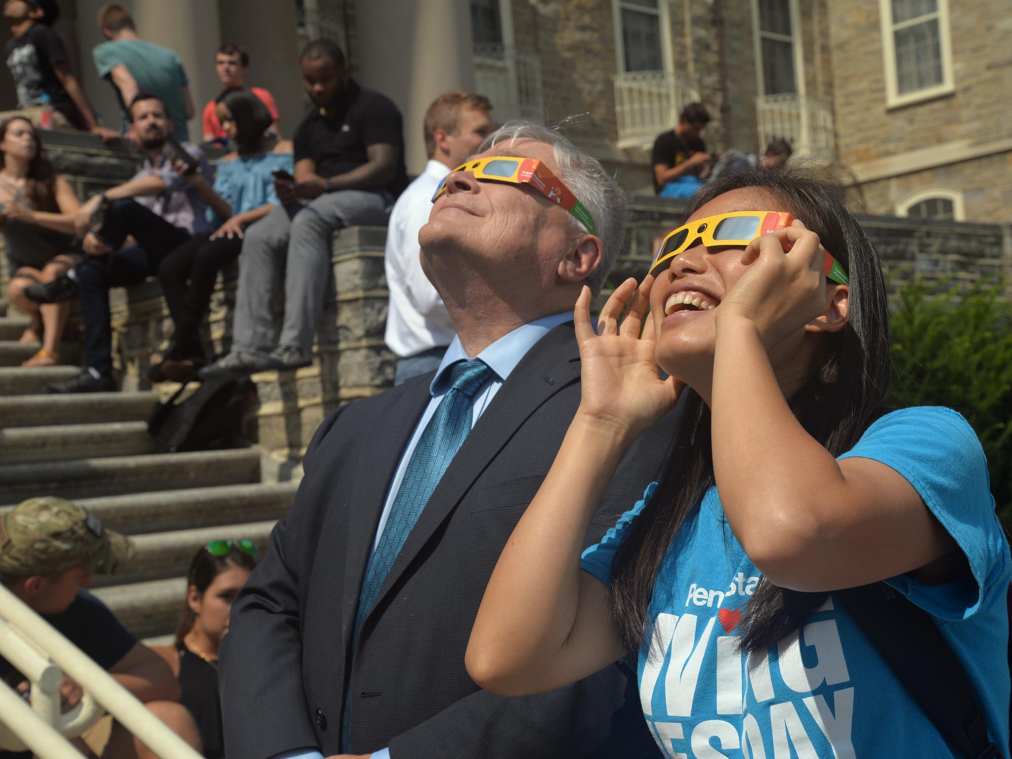Barron and a student watch the solar eclipse