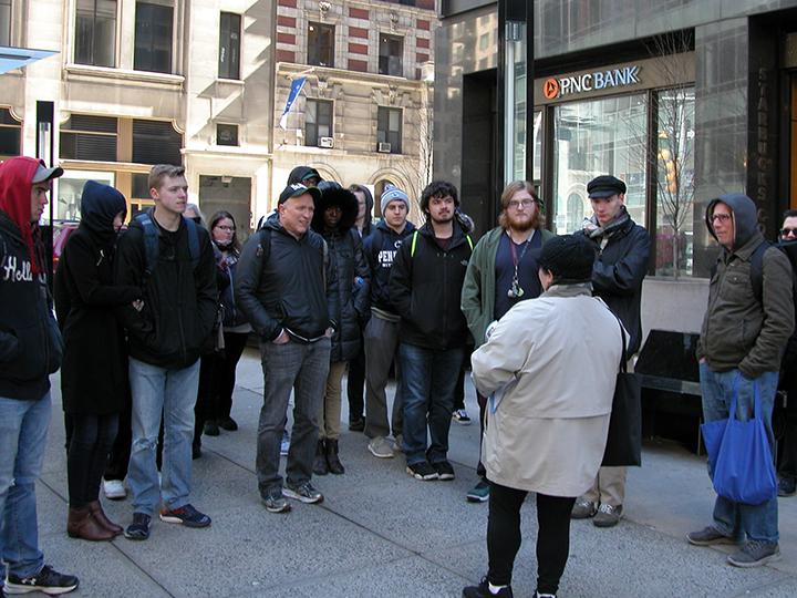 Tom Lynn (pictured fourth from left) and his students listened to a presentation by Beatles expert Susan Ryan (foreground).