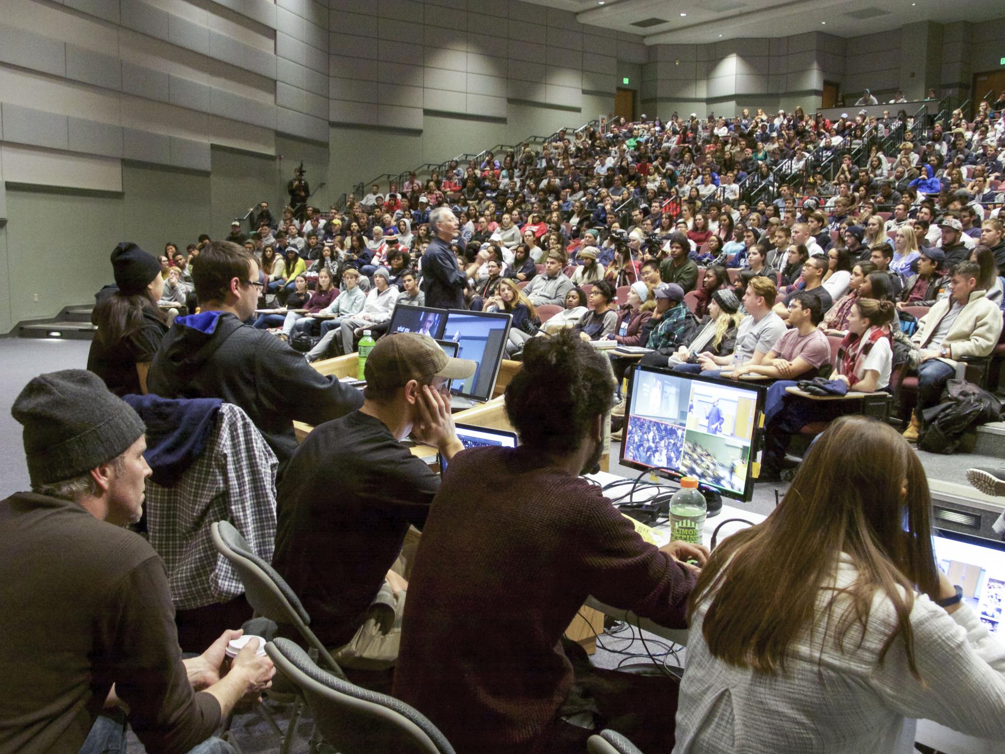 The live stream team sit in front of the class looking at their computer monitors