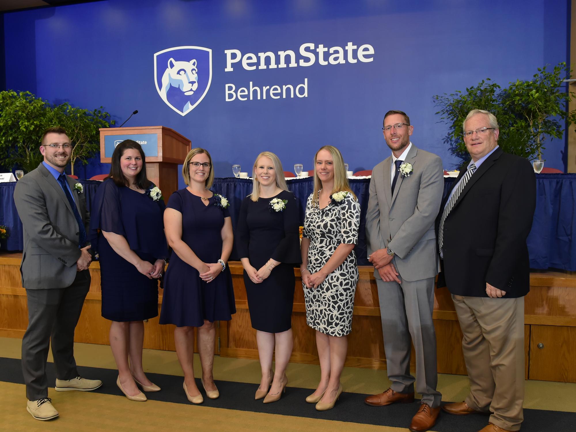 Six alumni members pose with Penn State Behrend Director of Athletics Brian Streeter.