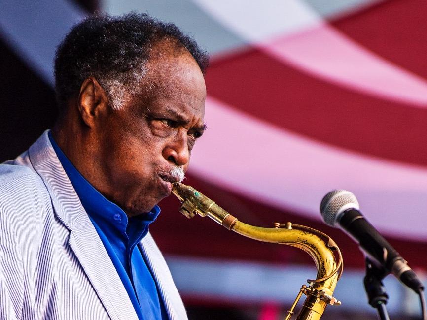 A man plays a saxophone.