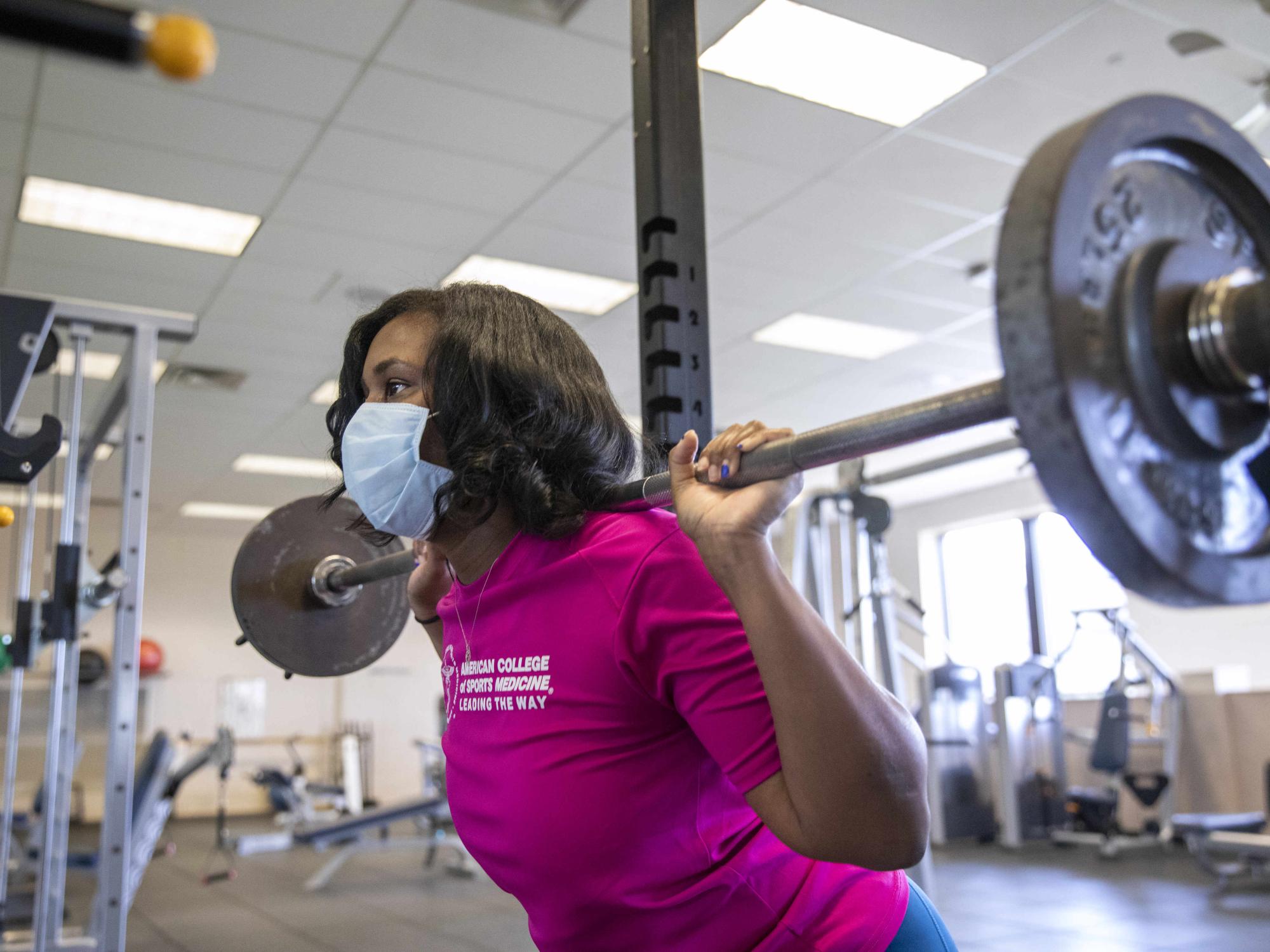 Natasha Renee Burse, a graduate student at Penn State College of Medicine, lifts weights at the University Fitness Center.