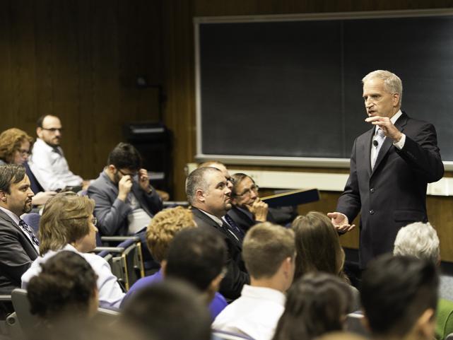 robert cardillo speaks to a crowd of people