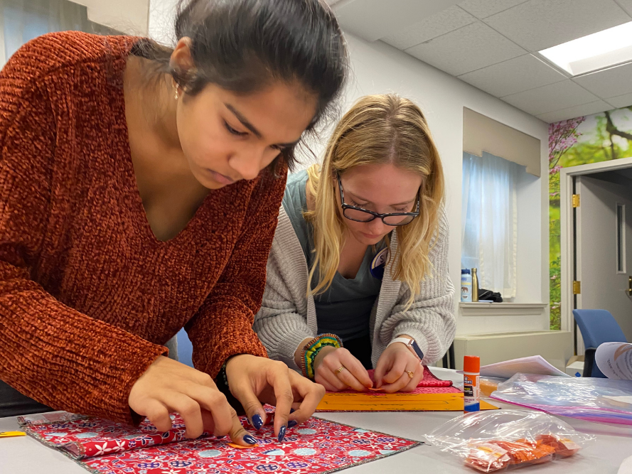 Shaka Ramanathan and Emma Cihanowyz working on menstrual kits