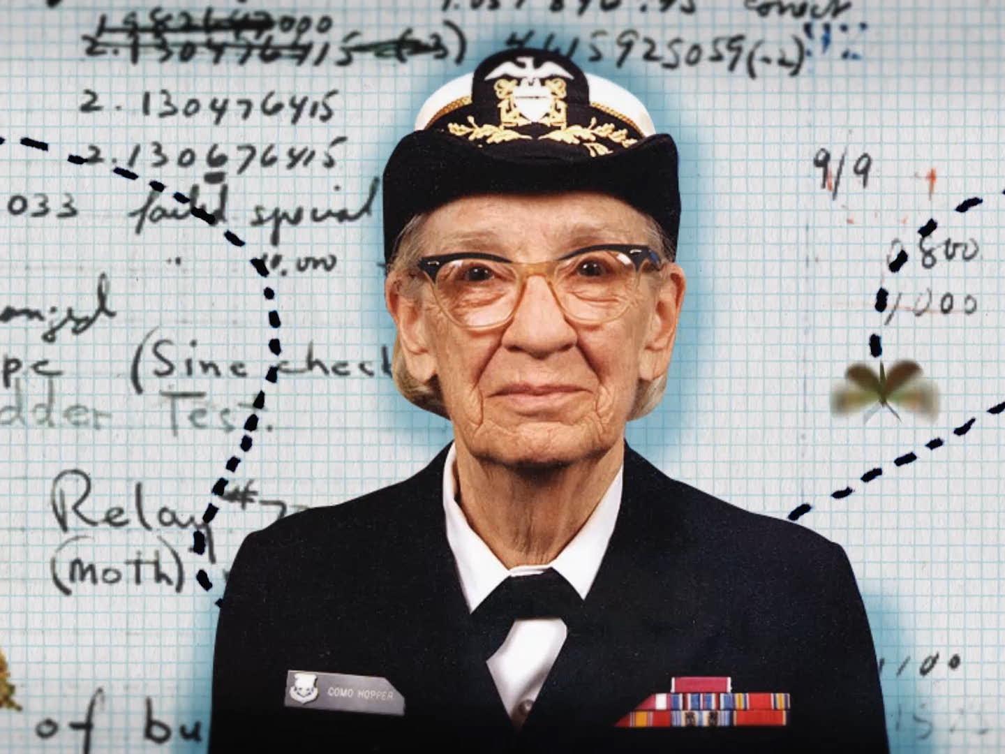 woman in United States Navy uniform in foreground, code instructions on graph paper in the background