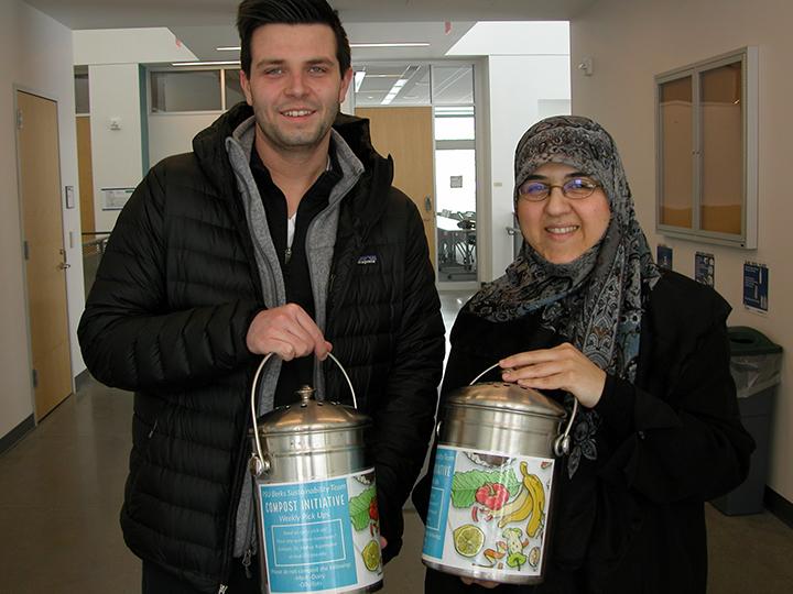 Senior Dakota Schoppe (left) and Dr. Mahsa Kazempour are pictured with the composting containers now found across campus. 