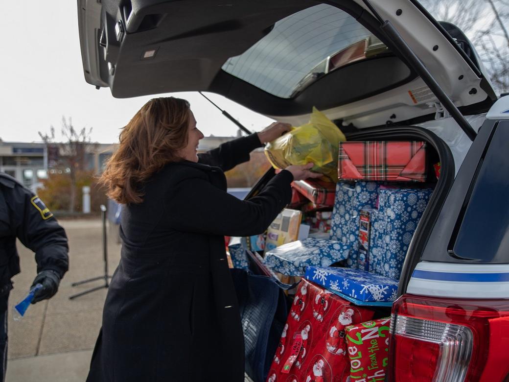 Woman places gifts in car
