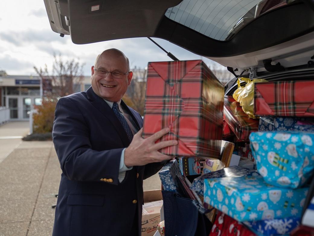 Man puts wrapped gift in car