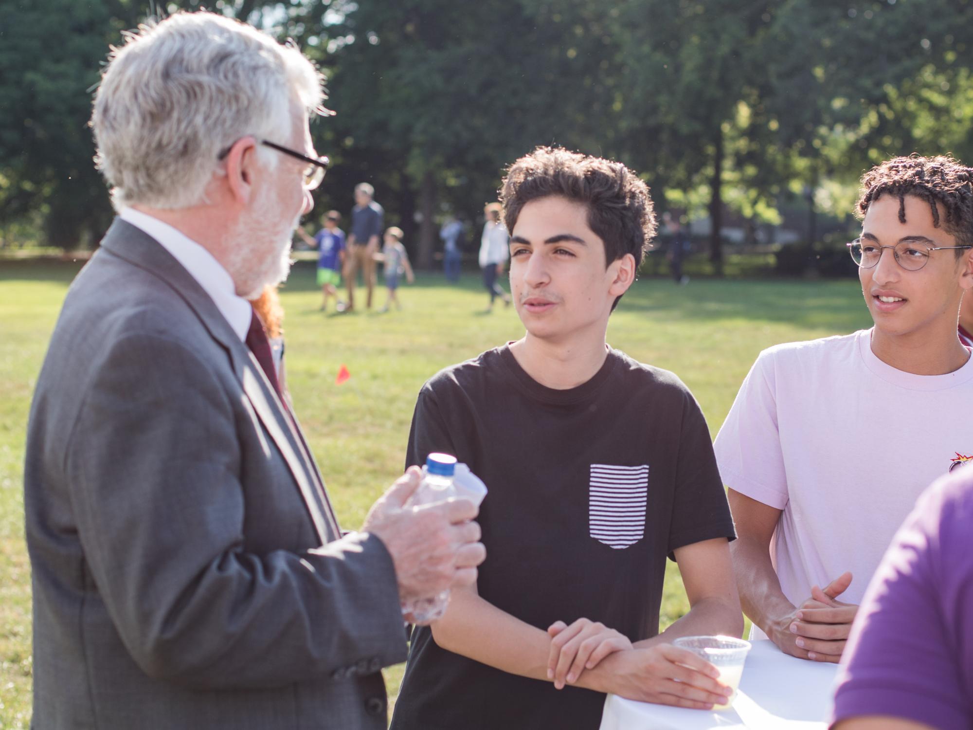 Dr. Robert Crane, interim Vice Provost for Global Programs, converses with students on Old Main Lawn