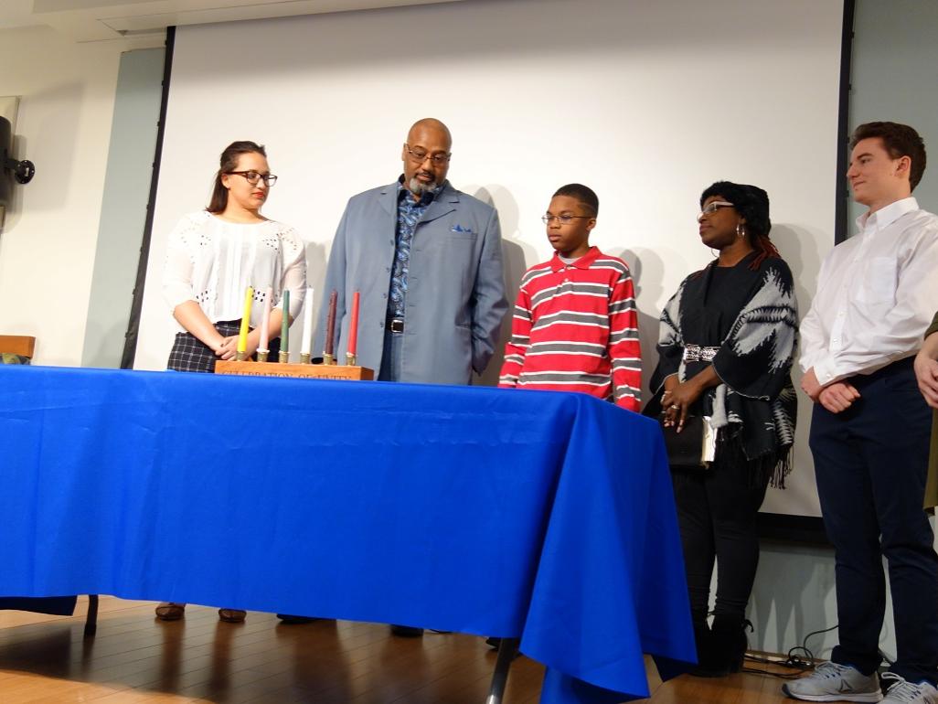 Campus and community members prepare to light the unity candle.