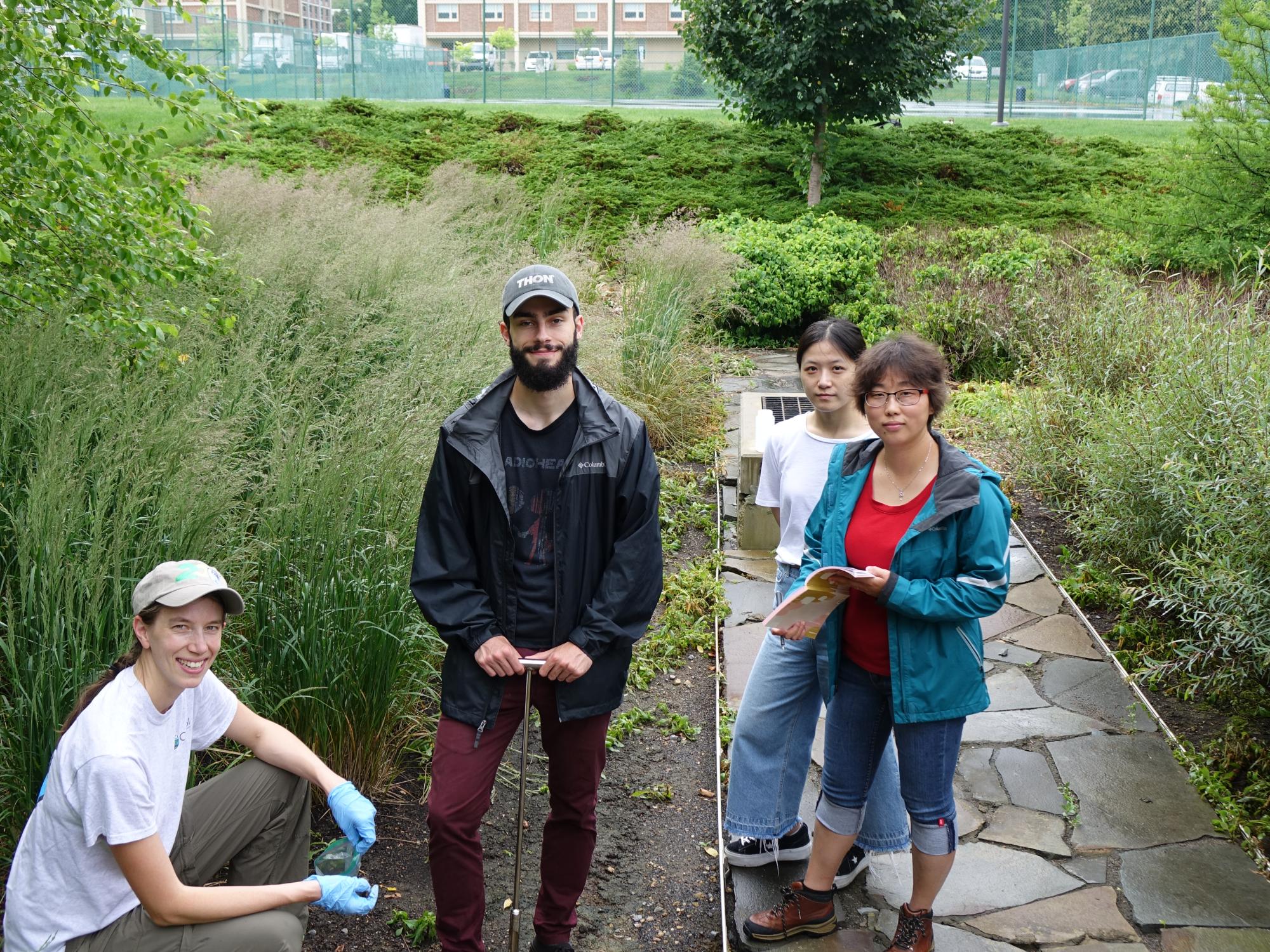 Lauren McPhillips, Jeffery D. Zaengle, Rui Wang, and Hong Wu stop for a photo in the roof drain 