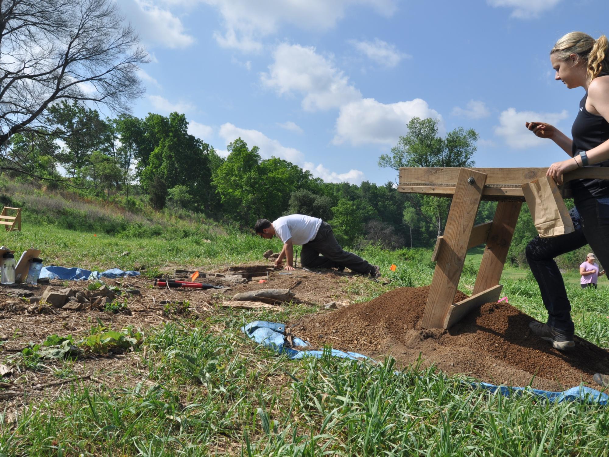 a view of students sifting the soil