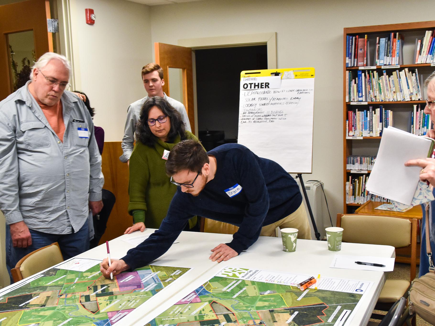 Bryce Brucker, a fourth-year landscape architecture student, takes notes on a map of the MG2V property.