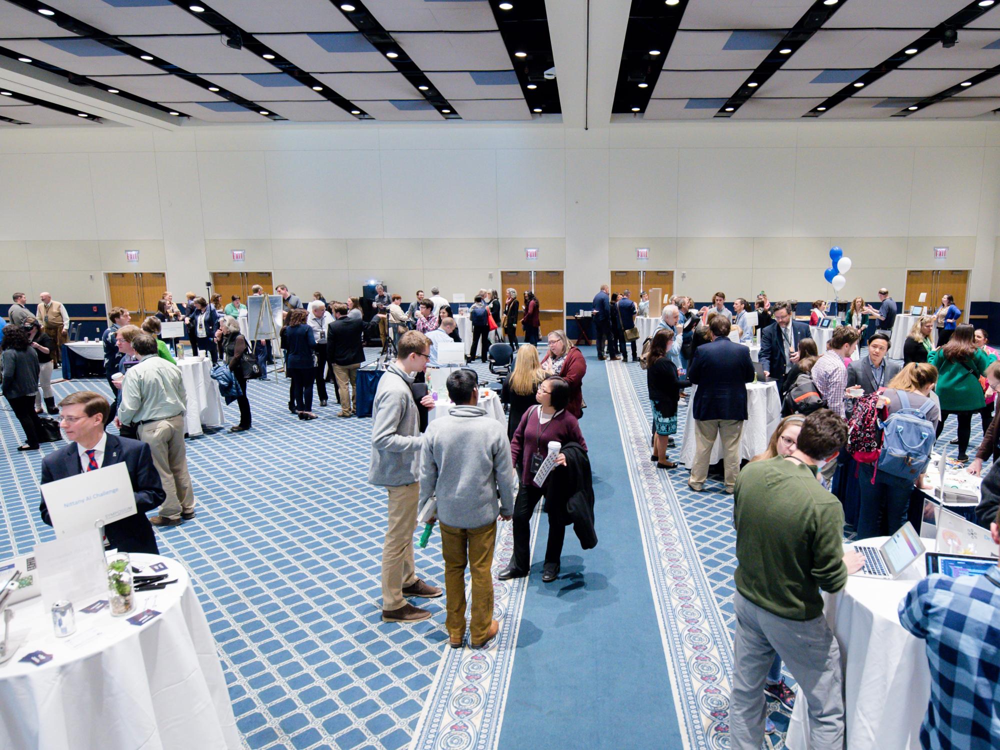 attendees walk around, checking out various tables