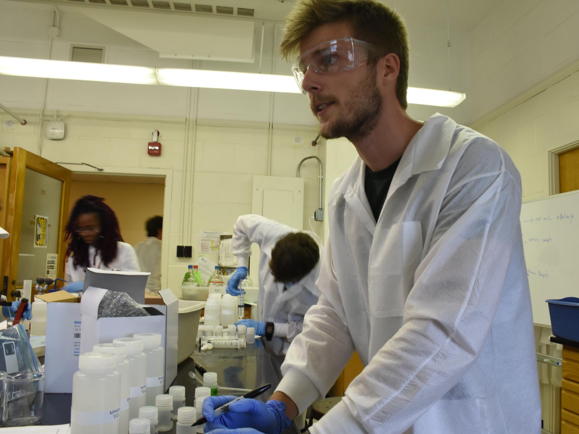 Mike Forgeng and students in GEOSC 413 “Techniques in Environmental Geochemistry” test the samples in the laboratory for nitrate, sulfate, chloride and metals like iron and manganese. 