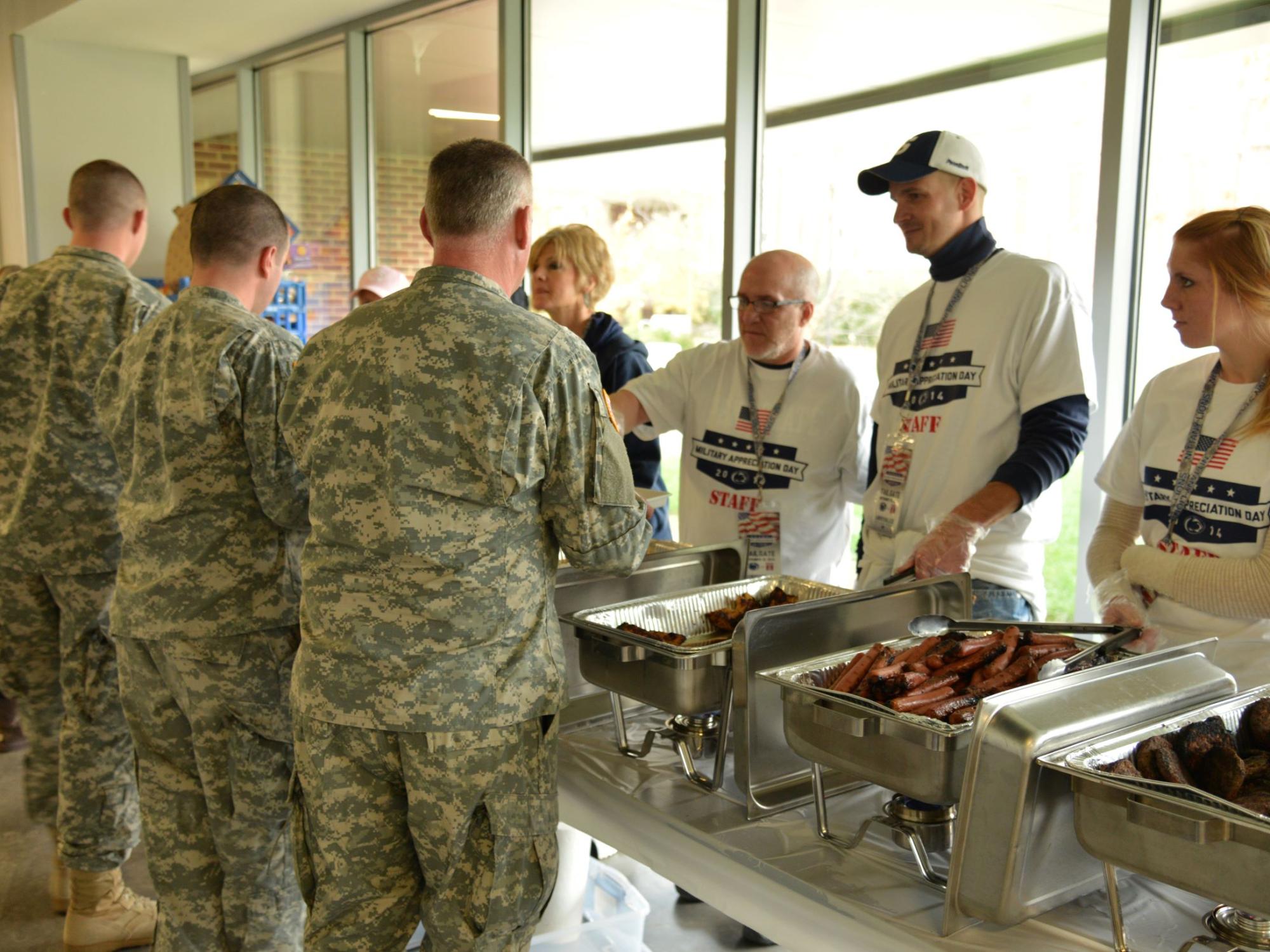 Attendees in line for food at 2014 Military Appreciation Tailgate