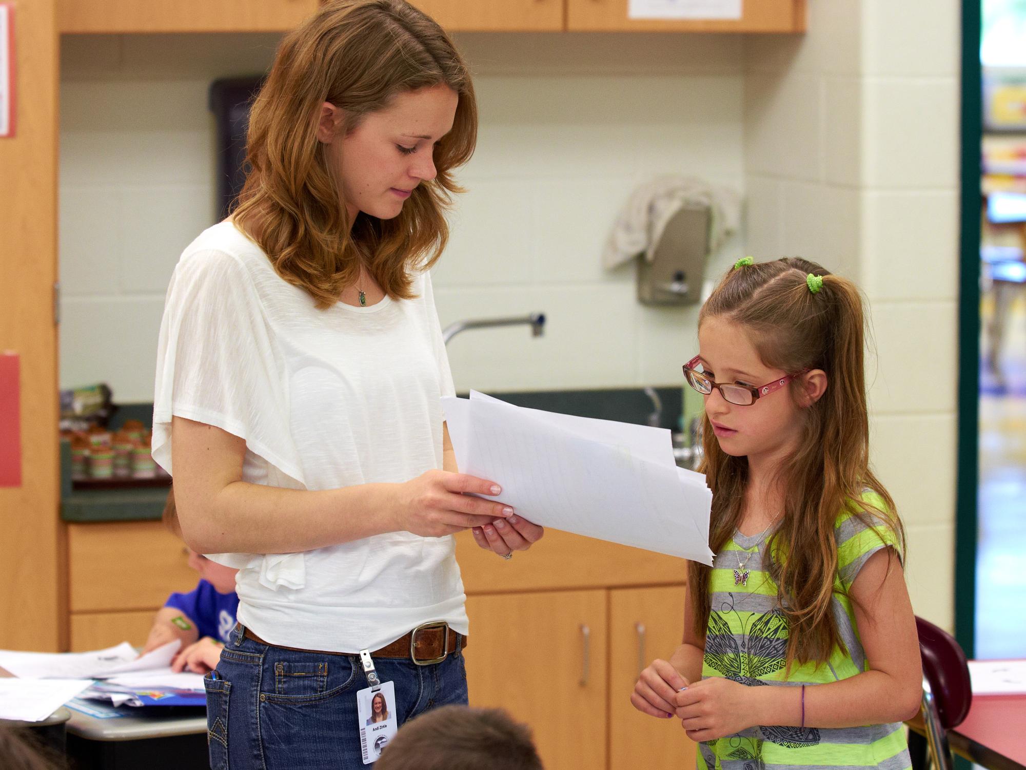Andi Zirkle, PDS intern, reviews a writing assignment with one of her students.