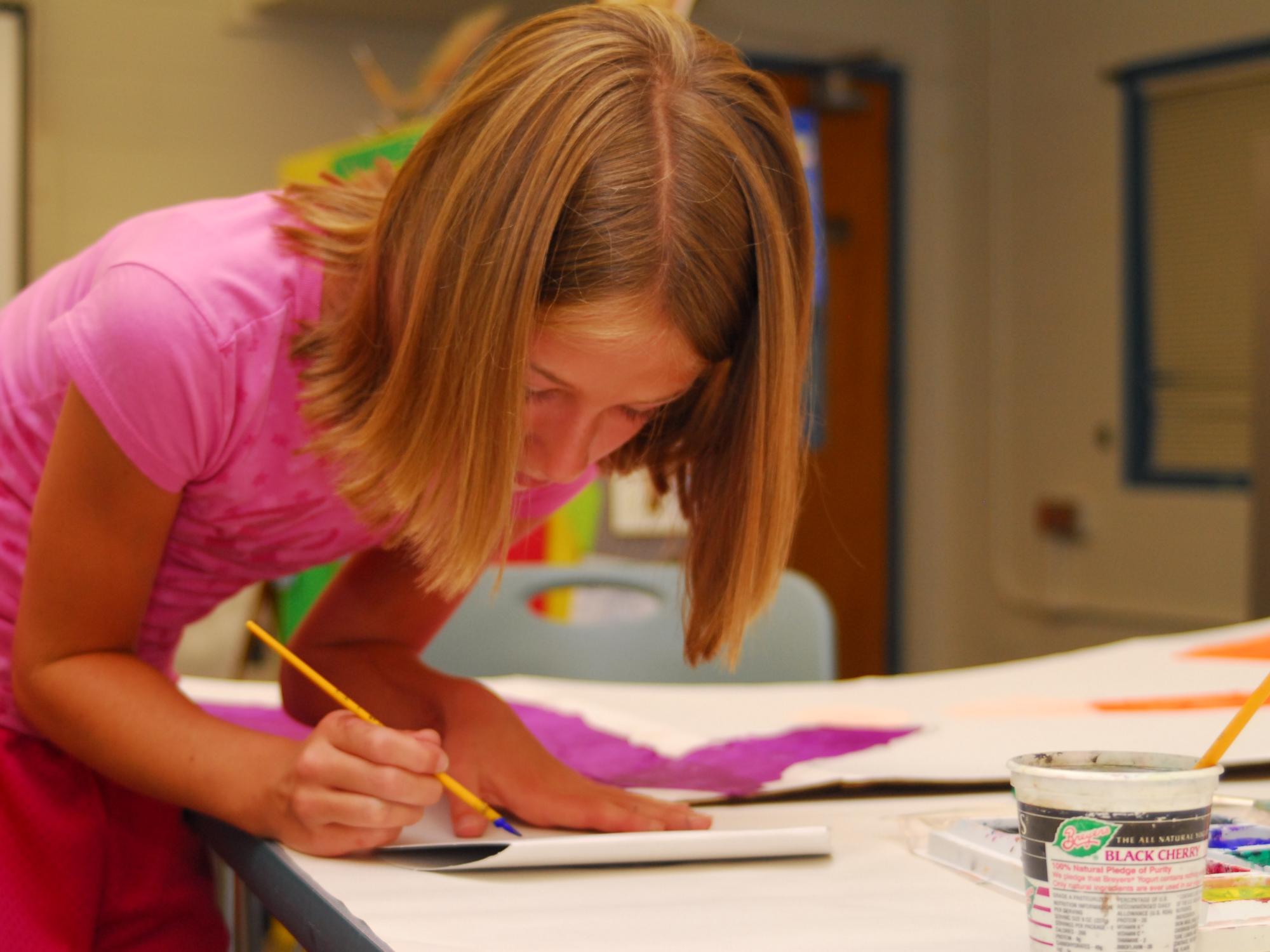 A student at the Summer Reading Camp translates what she has learned into a piece of art.