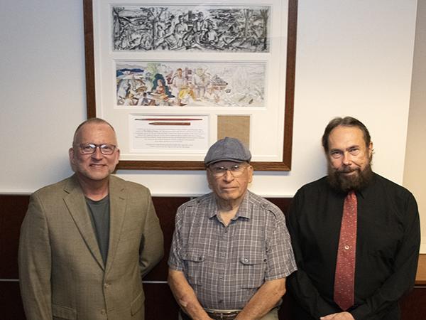 Charles Patrick, chancellor and chief academic officer; Frank R. Melega, son of the artist; and Patrick Daugherty, co-founder of the Frank L. Melega Museum, stand before the new installation.