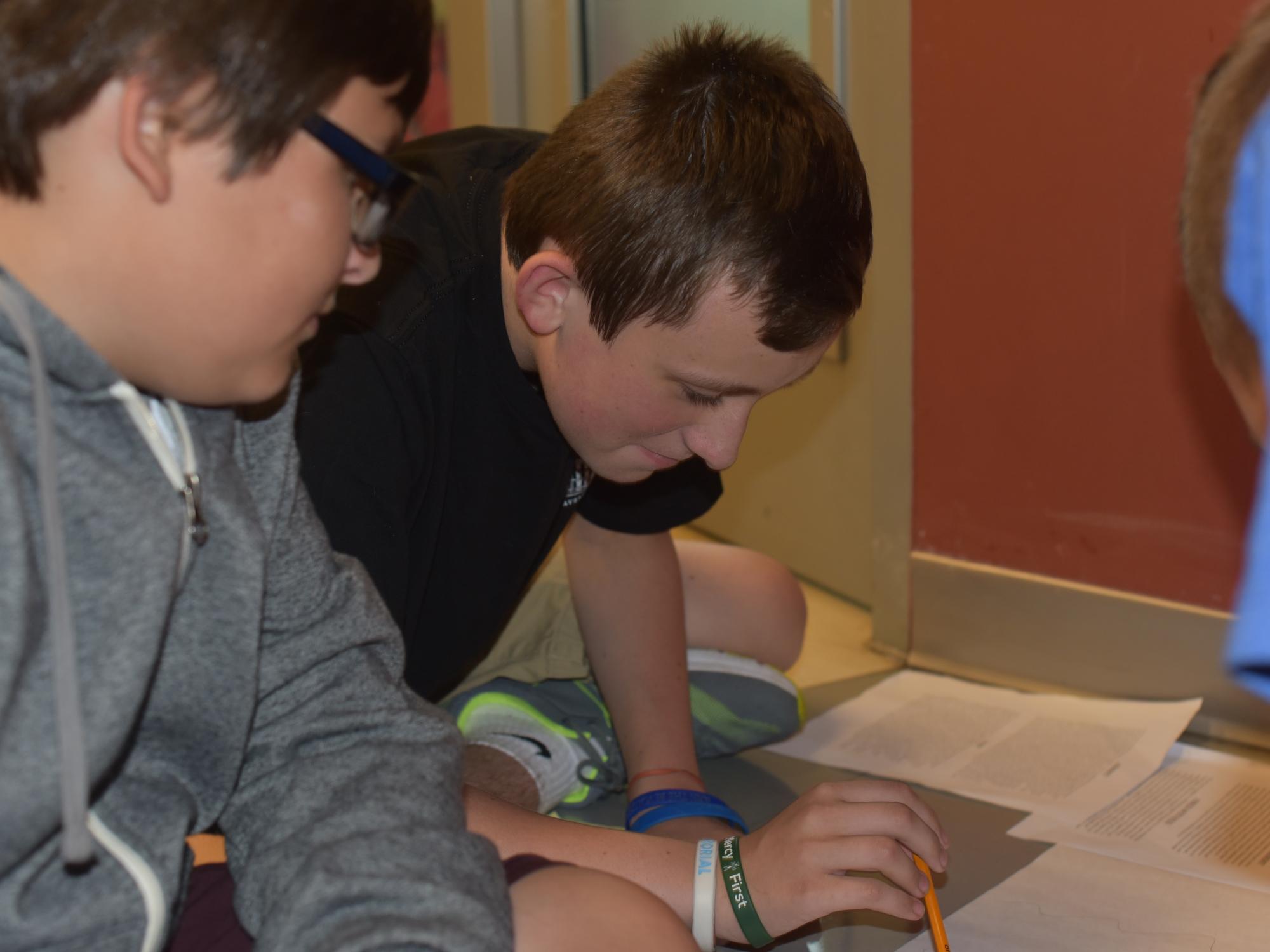 Students examine red dye during College for Kids.