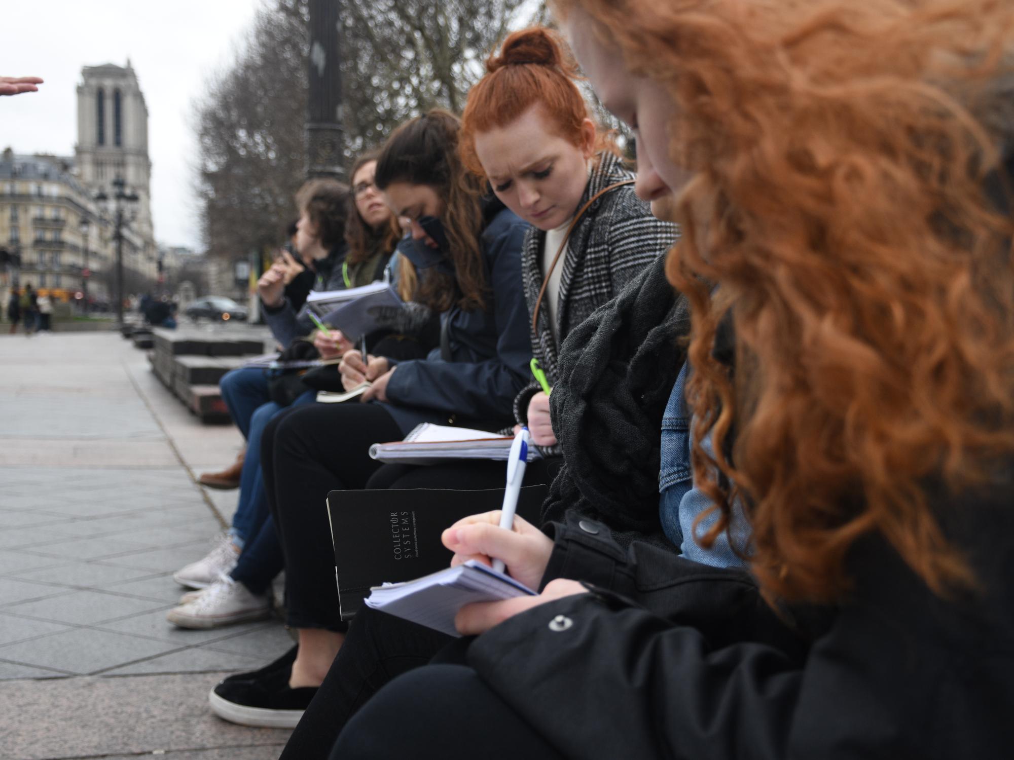 The students take notes during one of their tours.