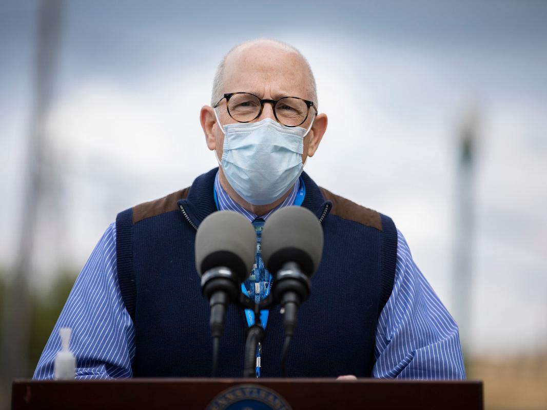A doctor speaks at a podium 