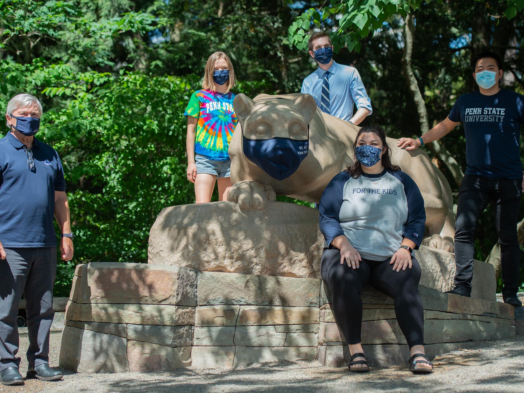 President Eric J. Barron was joined by student leaders to debut a mask on the Nittany Lion Shrine.