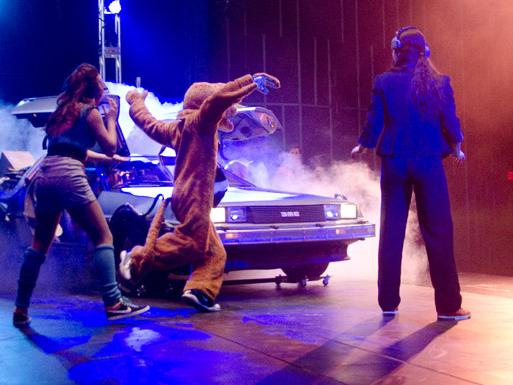 The Lion dancing in front a DeLorean 