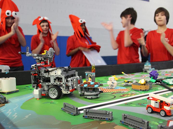A team cheers on their robot during the competition rounds of the FIRST Lego League event