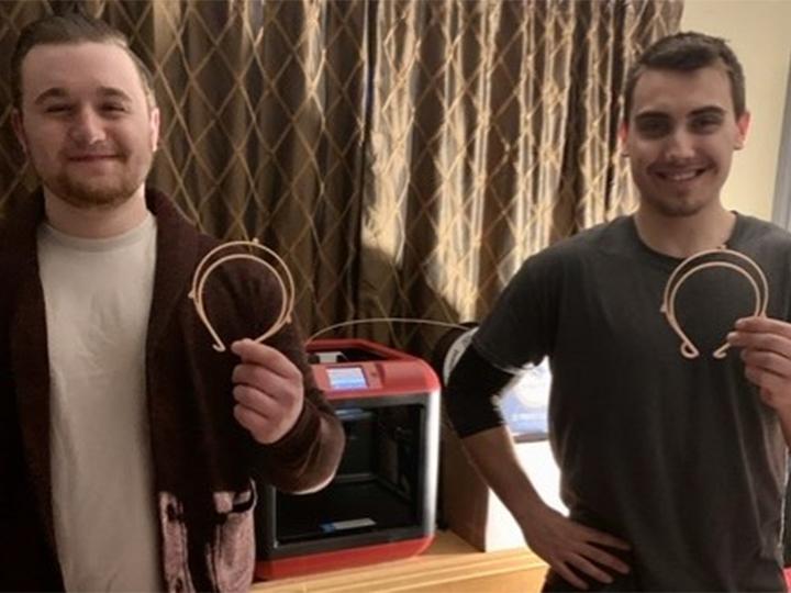 Dalton Butz and Gabriel Moyer show off their 3D semi-circle for face shields.