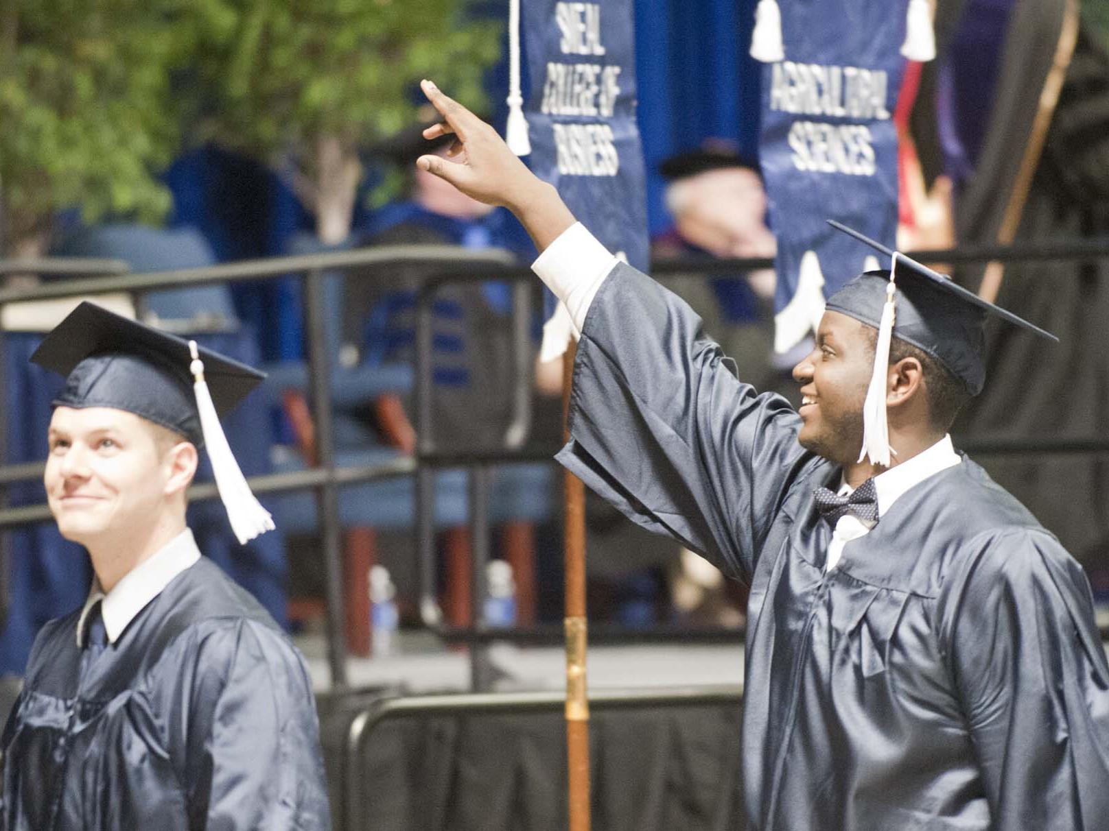 Matthew Savage points to family after getting his diploma