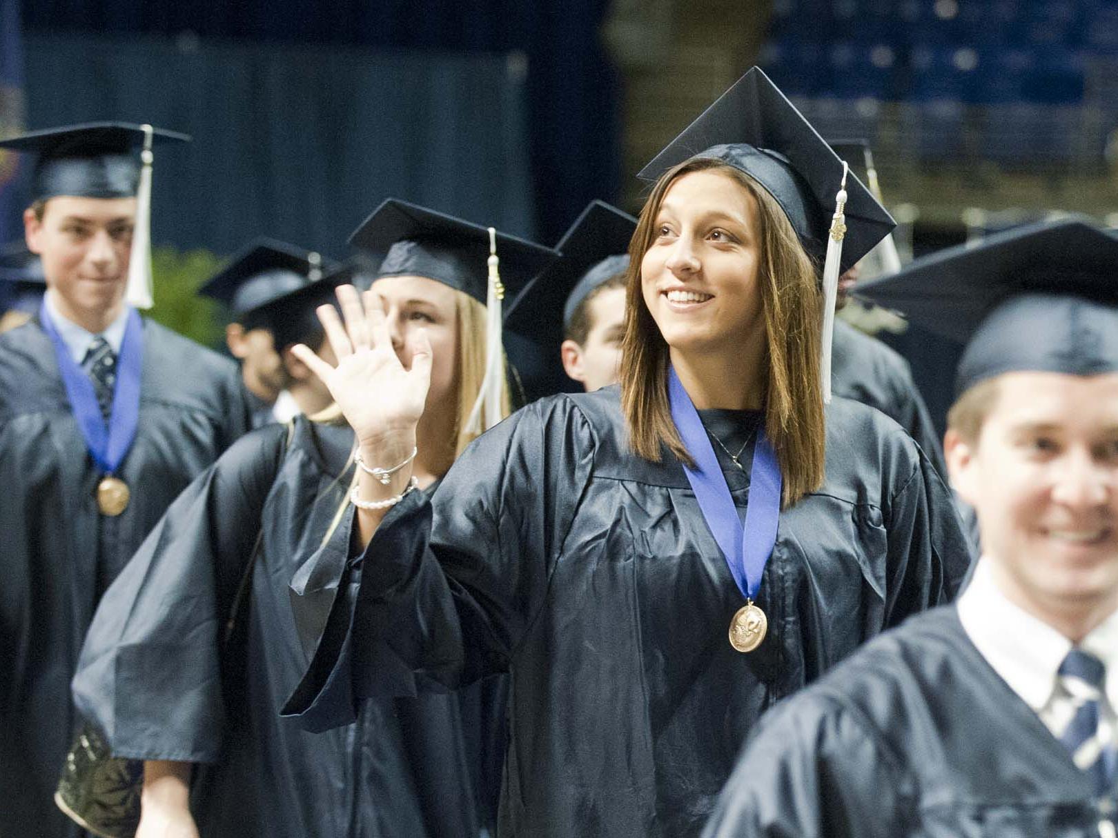 A new graduate waving 