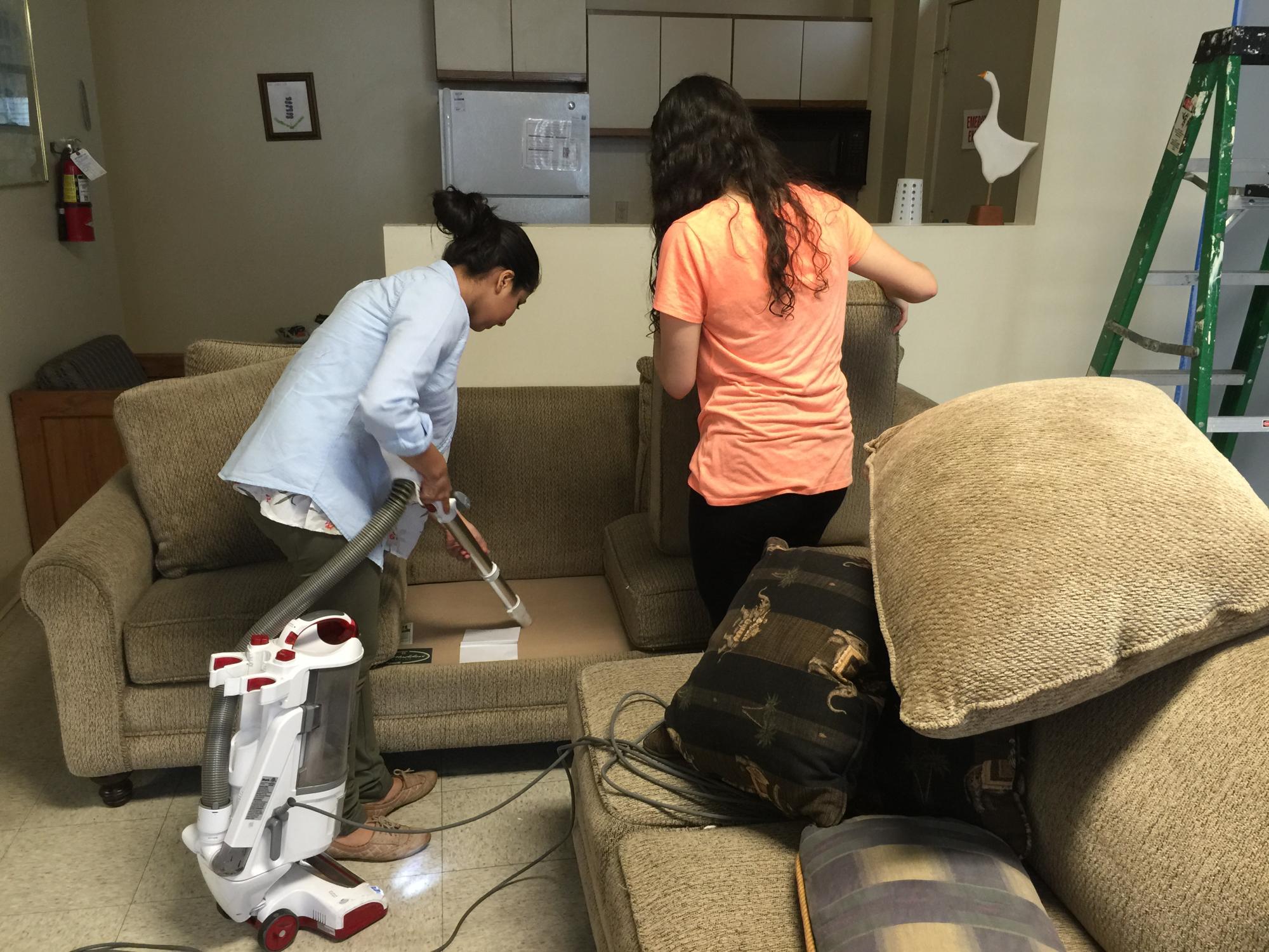 Student cleaning a couch