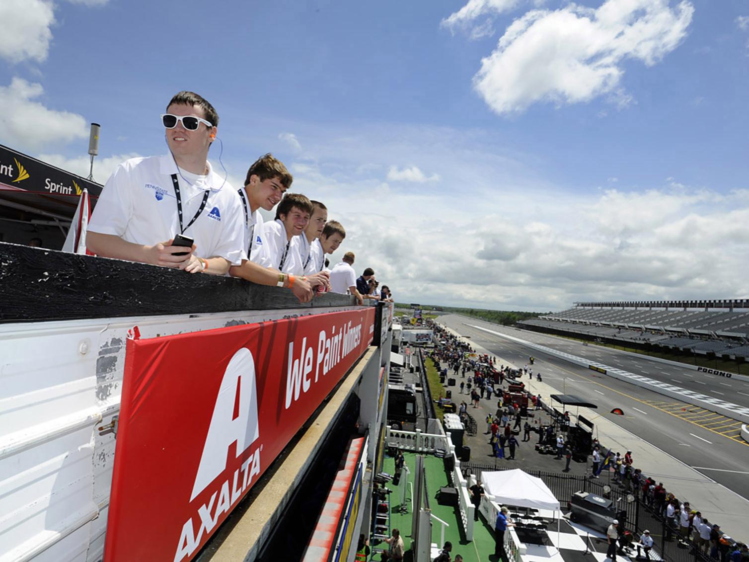 Students watching from the raceway's terrace